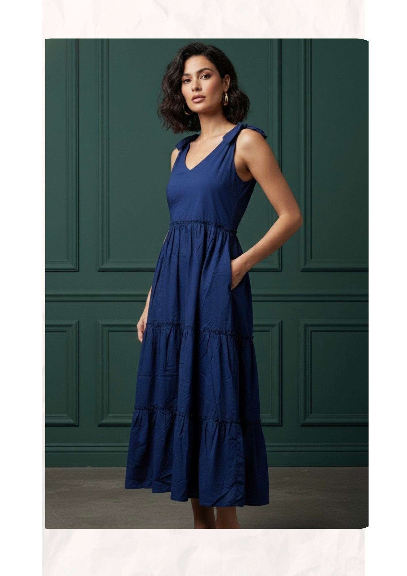 Woman wearing a blue dress against a green paneled wall